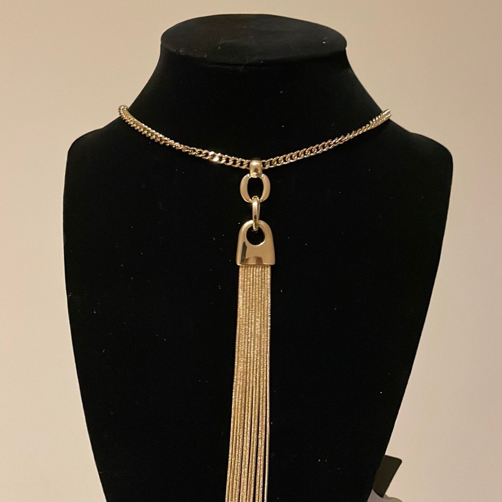 21 inches long very chic golden color good quality tassel necklace.
